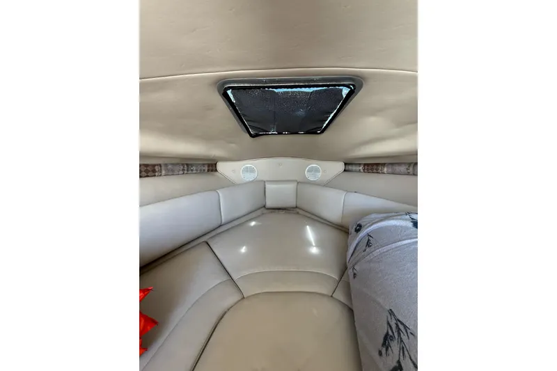 Slide: The Image of Interior cabin of 2000 Chaparral Signature 240 boat with beige seating and skylight. - 35