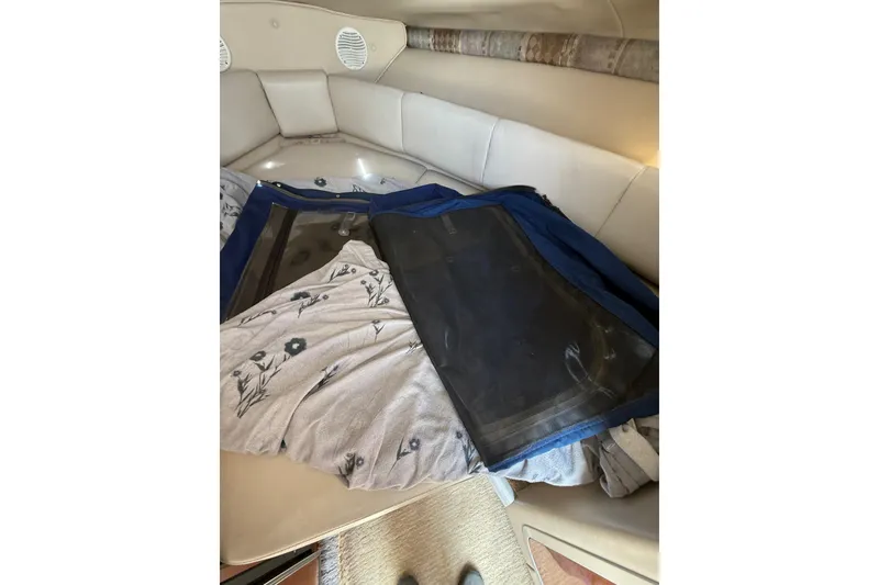 Slide: The Image of Interior of 2000 Chaparral Signature 240 boat with cushions and floral blanket. - 36