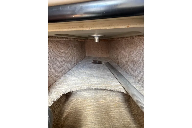 Slide: The Image of Interior view of 2000 Chaparral Signature 240 boat cabin with carpeted flooring. - 38