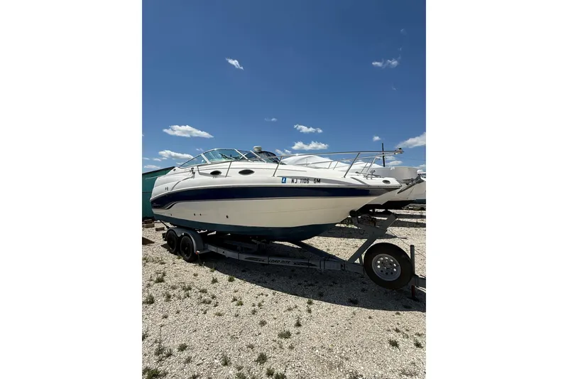 Slide: The Image of 2000 Chaparral Signature 240 boat on trailer under clear blue sky. - 5
