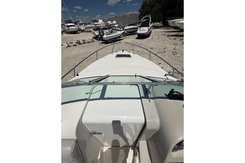 Slide: The Image of 2000 Chaparral Signature 240 boat on dry dock, surrounded by other vessels. - 51