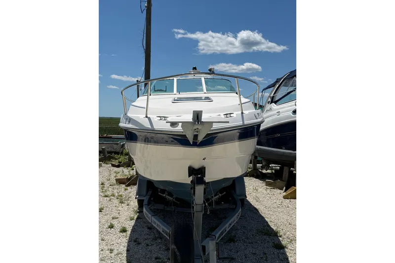 Slide: The Image of 2000 Chaparral Signature 240 boat on trailer under clear blue sky. - 6
