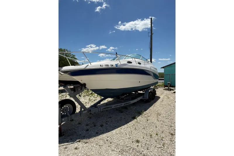 Slide: The Image of Chaparral Signature 240 boat from 2000 on a trailer under a clear blue sky. - 8
