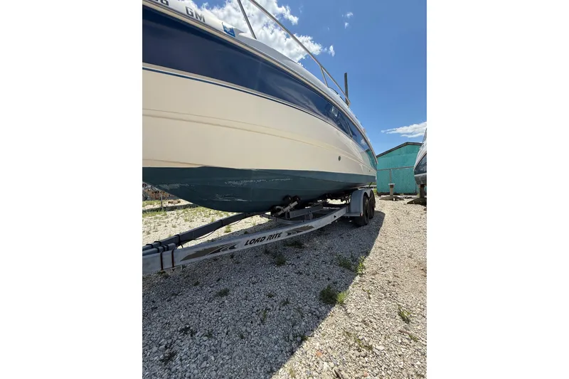 Slide: The Image of 2000 Chaparral Signature 240 boat on trailer under clear blue sky. - 9
