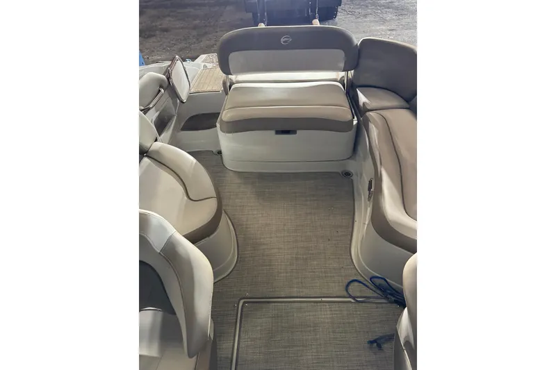 The Image of 2022 Crownline Eclipse E255 boat interior with beige seating and carpeted floor. - 10