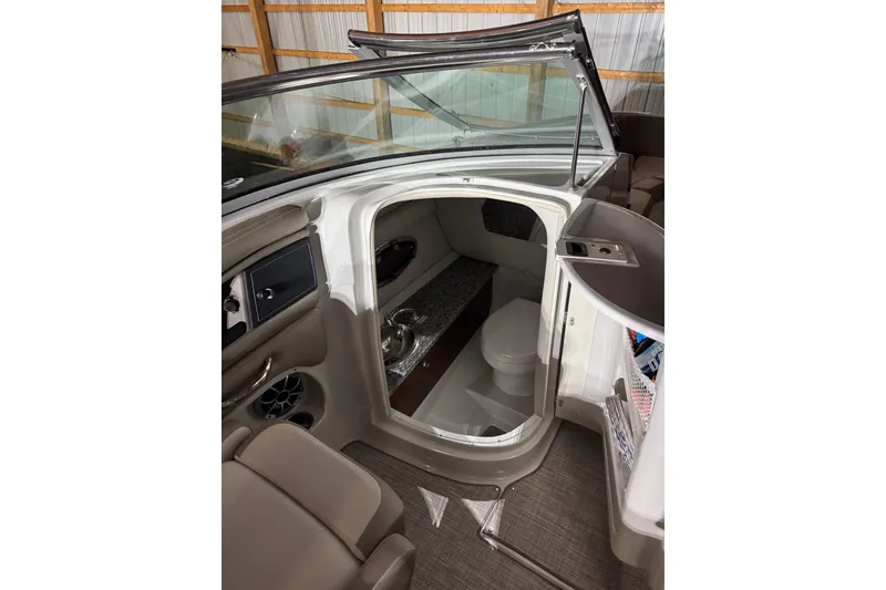 Slide: The Image of Interior view of 2022 Crownline Eclipse E255 boat cabin with seating and amenities. - 12