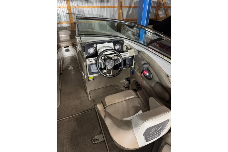 Slide: The Image of Interior view of 2022 Crownline Eclipse E255 boat cockpit with steering wheel and controls. - 13