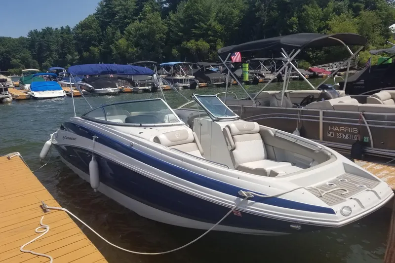 Slide: The Image of 2022 Crownline Eclipse E255 boat docked at a marina with other boats. - 15