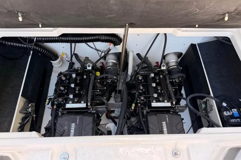 Slide: The Image of 2024 Yamaha Boats AR220 engine compartment with dual engines and wiring. - 10