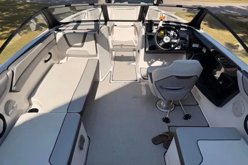 Slide: The Image of 2024 Yamaha Boats AR220 interior with seating and steering wheel, showcasing modern design. - 8