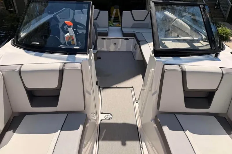 Slide: The Image of 2024 Yamaha Boats AR220 interior with seating and windshield, showcasing modern design. - 9