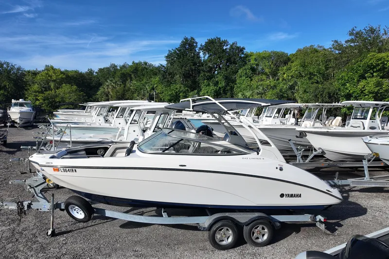 The Image of 2017 Yamaha Boats 242 Limited S E-Series on trailer, surrounded by other boats. - 0