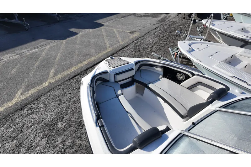 Slide: The Image of 2017 Yamaha Boats 242 Limited S E-Series bow seating area, docked on asphalt. - 5