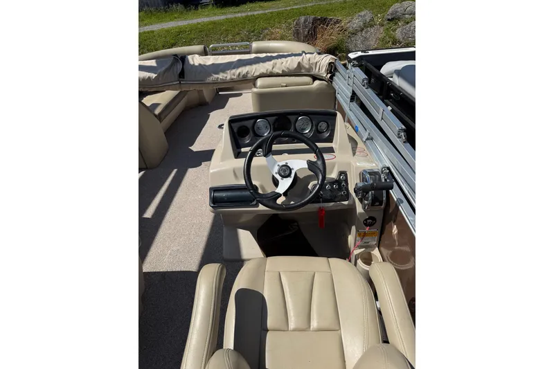 Slide: The Image of 2012 Harris FloteBote Sunliner 220 boat interior with steering wheel and dashboard controls. - 8