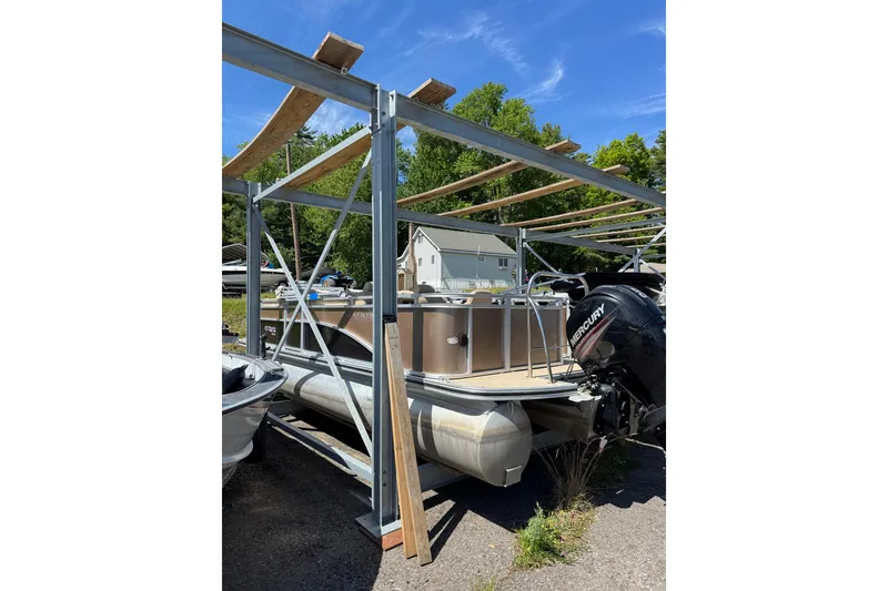 Slide: The Image of 2012 Harris FloteBote Sunliner 220 pontoon boat with Mercury engine in storage. - 9