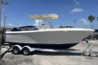 The Image of 2022 Sailfish 242 CC boat on trailer under clear blue sky. - 1