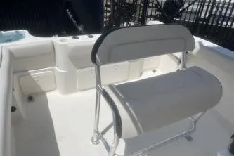 Slide: The Image of 2022 Sailfish 242 CC boat interior with cushioned seating and storage compartments. - 11