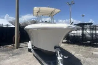 Slide: The Image of 2022 Sailfish 242 CC boat on trailer under clear blue sky. - 3