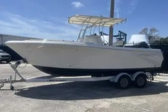 Slide: The Image of 2022 Sailfish 242 CC boat on trailer, parked outdoors under clear sky. - 4