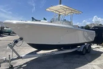 Slide: The Image of 2022 Sailfish 242 CC boat on trailer under clear blue sky. - 5