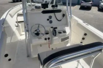 Slide: The Image of 2022 Sailfish 242 CC boat interior with steering console and seating. - 8