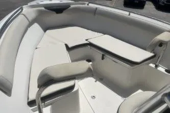 Slide: The Image of 2022 Sailfish 242 CC boat interior with cushioned seating and table. - 9