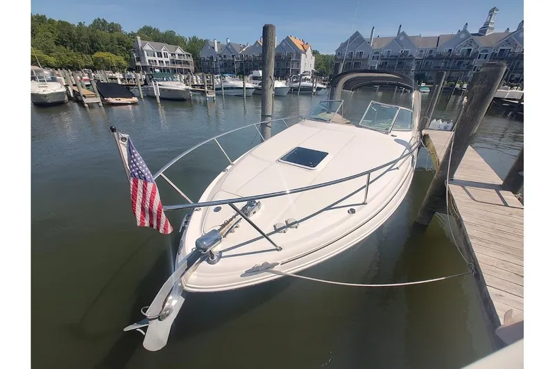 Slide: The Image of 2003 Sea Ray Sundancer 280 docked at marina with American flag. - 1