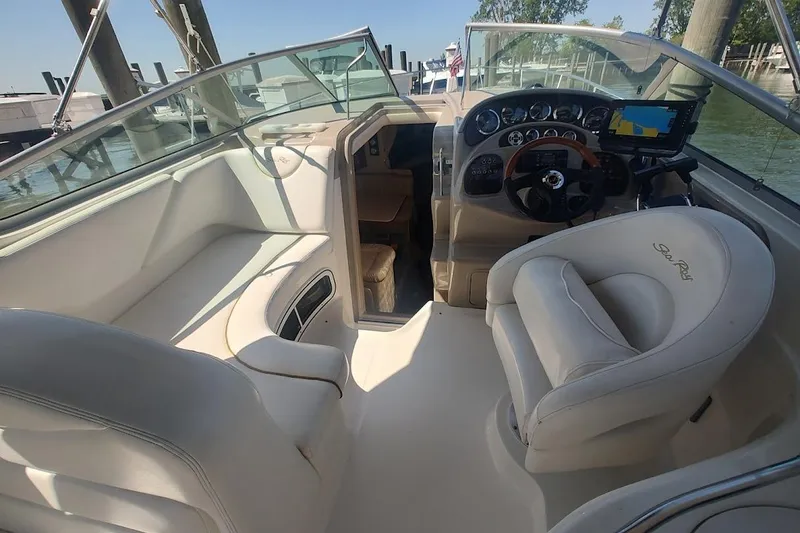 Slide: The Image of Interior of a 2003 Sea Ray Sundancer 280 boat, featuring helm and seating area. - 11