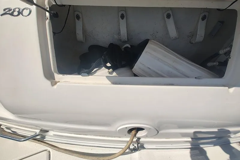 Slide: The Image of Storage compartment of a 2003 Sea Ray Sundancer 280 boat with equipment inside. - 17