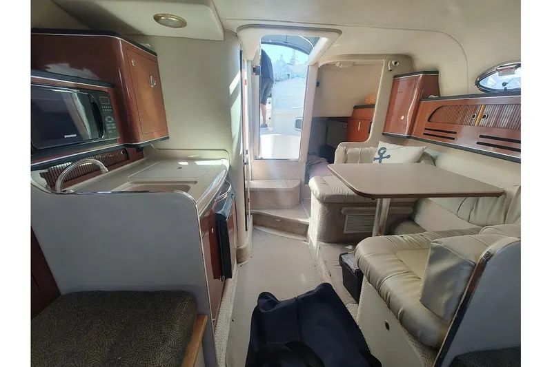 Slide: The Image of Interior of 2003 Sea Ray Sundancer 280 yacht with kitchenette and seating area. - 27