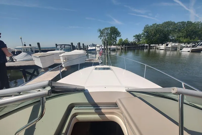 Slide: The Image of 2003 Sea Ray Sundancer 280 docked at marina, clear sky, calm water. - 4