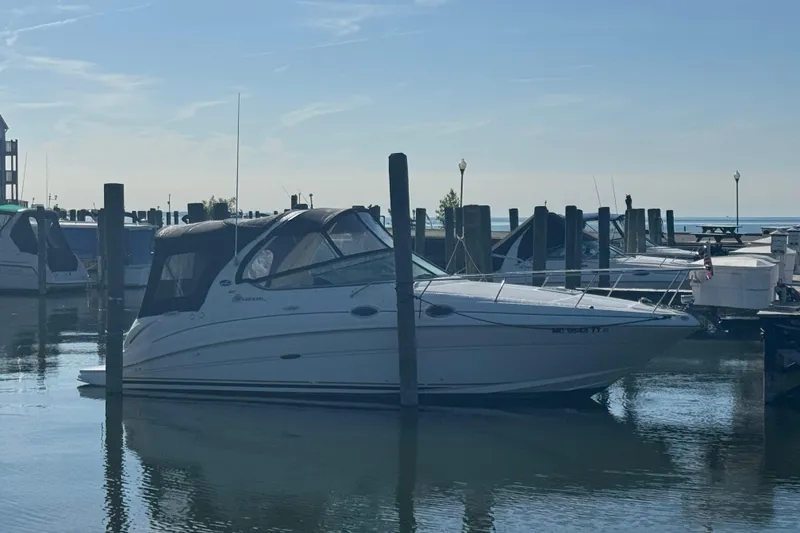 Slide: The Image of 2003 Sea Ray Sundancer 280 docked at a marina under clear skies. - 44
