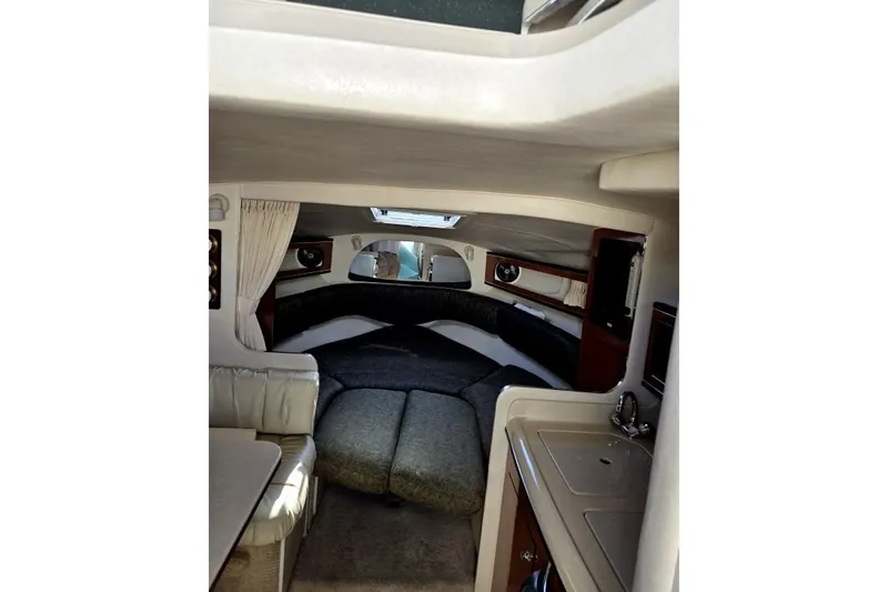 Slide: The Image of Interior of 2003 Sea Ray Sundancer 280, featuring cozy seating and compact kitchenette. - 47