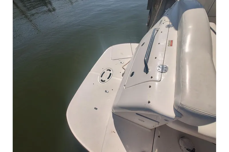 Slide: The Image of 2003 Sea Ray Sundancer 280 boat deck with seating, docked by water. - 8