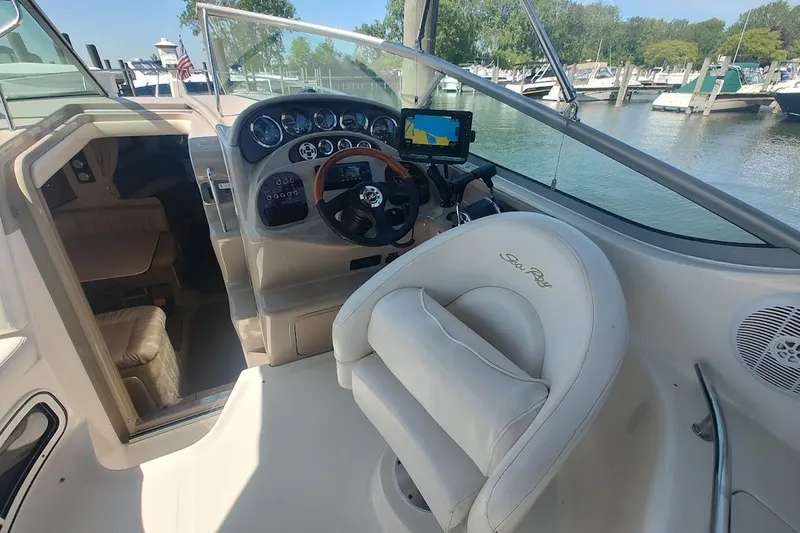 Slide: The Image of 2003 Sea Ray Sundancer 280 helm with steering wheel and navigation system. - 9