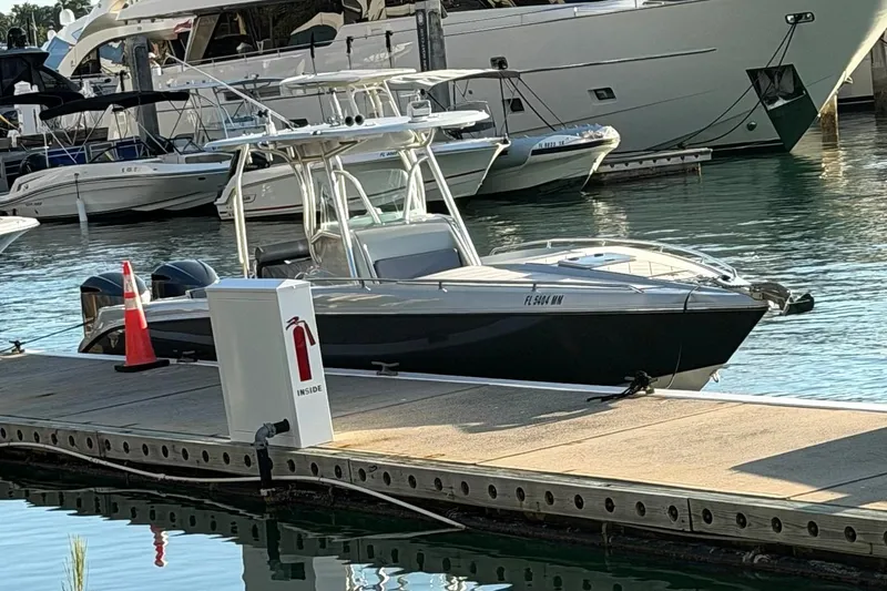 The Image of 2004 Baja 340 Sportfish docked at marina with other boats in background. - 0
