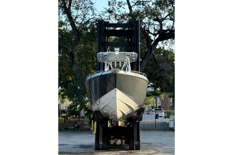 Slide: The Image of 2004 Baja 340 Sportfish boat on a lift, surrounded by trees. - 3