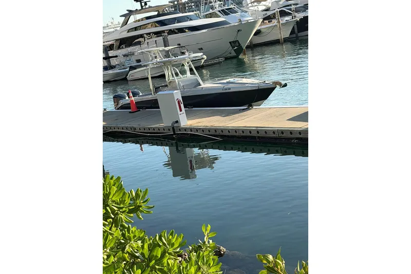 Slide: The Image of 2004 Baja 340 Sportfish docked at marina, surrounded by luxury yachts. - 4