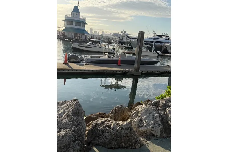 Slide: The Image of Marina view with 2004 Baja 340 Sportfish boat docked, surrounded by yachts. - 5