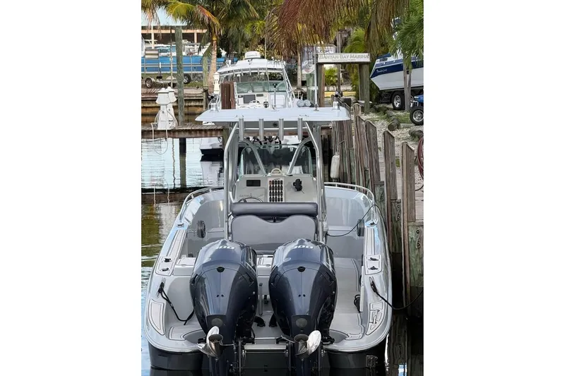 Slide: The Image of 2004 Baja 340 Sportfish boat docked at marina with twin engines. - 7