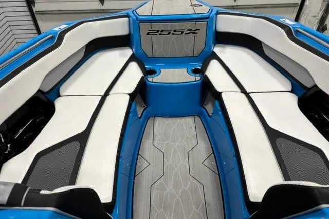Slide: The Image of 2023 Yamaha Boats 255XE interior with blue and white seating, showcasing modern design. - 10