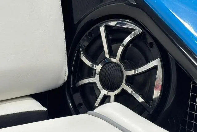 Slide: The Image of 2023 Yamaha Boats 255XE speaker detail with sleek design and white seating. - 17
