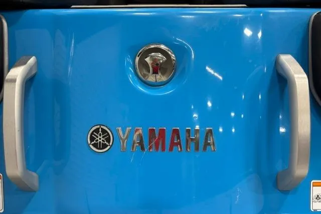 Slide: The Image of 2023 Yamaha Boats 255XE, blue exterior with logo and handles. - 21