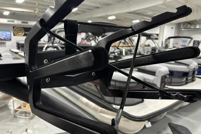 Slide: The Image of 2023 Yamaha Boats 255XE wakeboard rack in showroom, showcasing sleek design and functionality. - 26