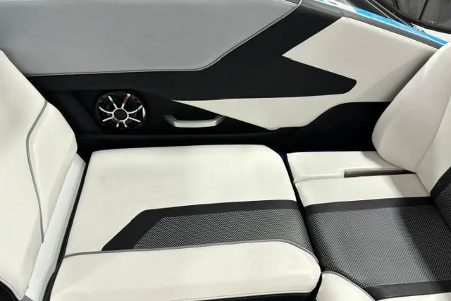 Slide: The Image of 2023 Yamaha Boats 255XE interior seating with modern design and integrated speaker system. - 28