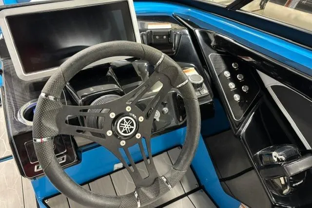 Slide: The Image of 2023 Yamaha Boats 255XE dashboard with steering wheel and control panel. - 5