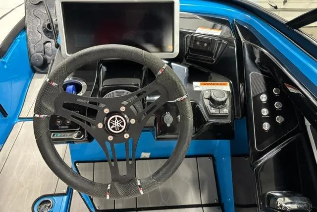 Slide: The Image of 2023 Yamaha Boats 255XE dashboard with steering wheel and control panel. - 6