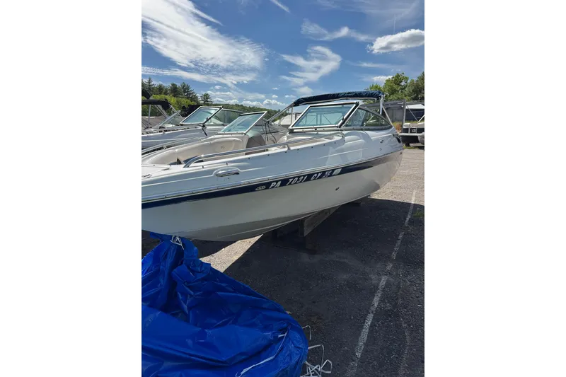 Slide: The Image of 2006 Crownline 21 Classic boat on trailer under clear blue sky. - 10