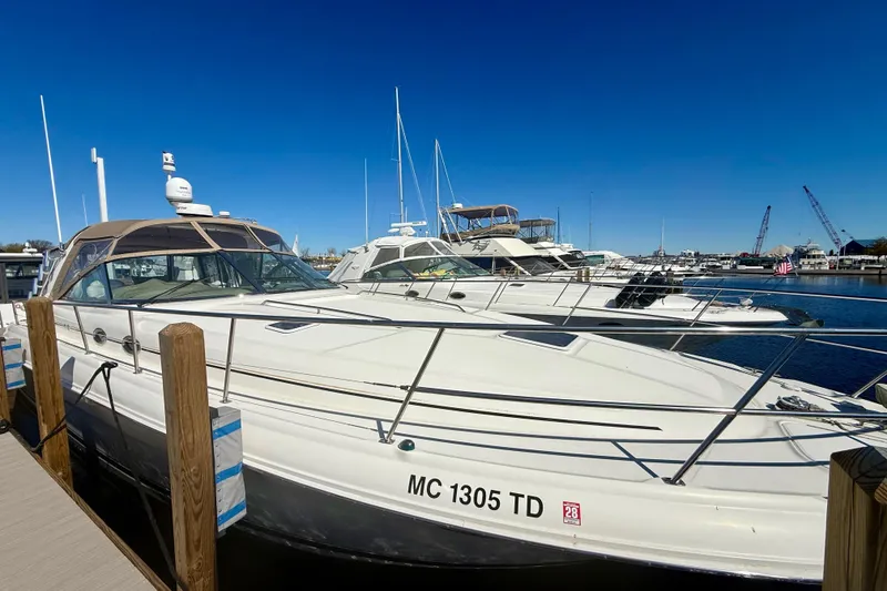 Slide: The Image of 2000 Sea Ray 410 Express Cruiser docked at marina under clear blue sky. - 1