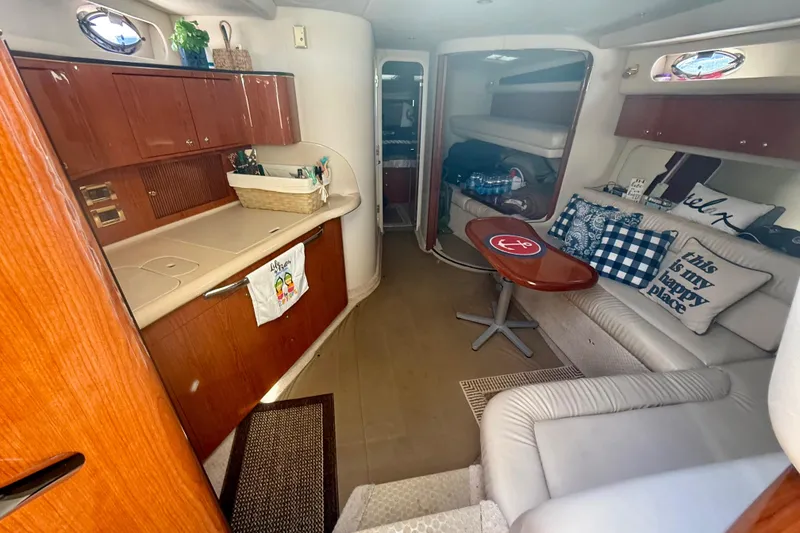 Slide: The Image of Interior of 2000 Sea Ray 410 Express Cruiser with cozy seating and wooden cabinetry. - 10